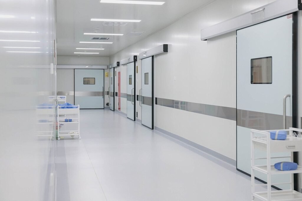 Real-world project site showcasing a modern hospital corridor with OSIDEK automatic hermetic sliding doors installed as part of our full-scale construction service.