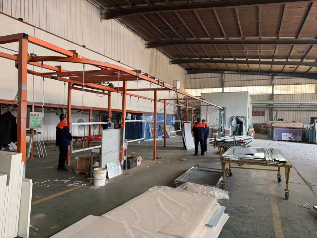 A real-world view inside the OSIDEK manufacturing facility, showcasing the production line for heavy-duty radiation shielding doors and medical cleanroom infrastructure.