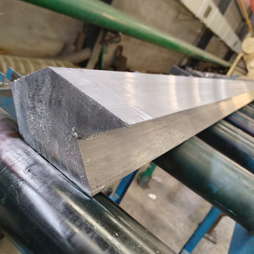 Close-up of high-purity raw lead shielding material on an OSIDEK factory roller, representing our advanced materials and precision engineering capabilities.